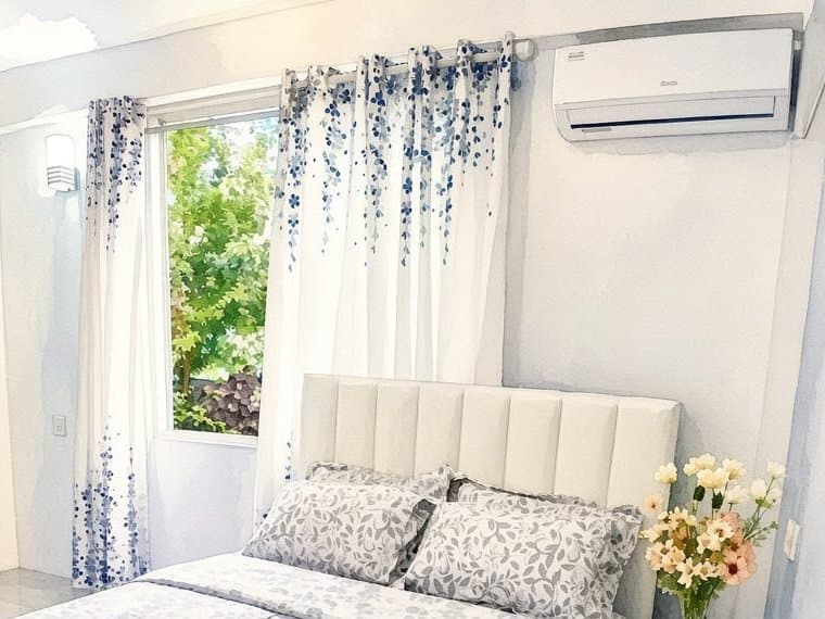 Bedroom window with blue floral curtains looking out onto the garden